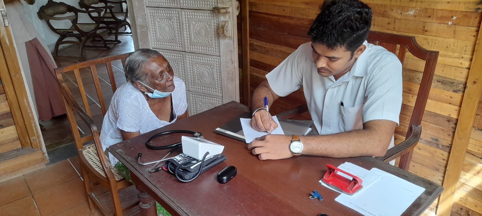 Ayurvie Weligama doctor consulting a local elder, reflecting the social impact values of this ayurveda hotel in Sri Lanka.