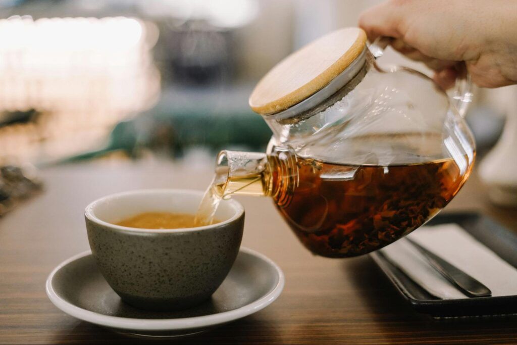 Freshly brewed Ceylon tea poured into a cup, showing its clear amber colour